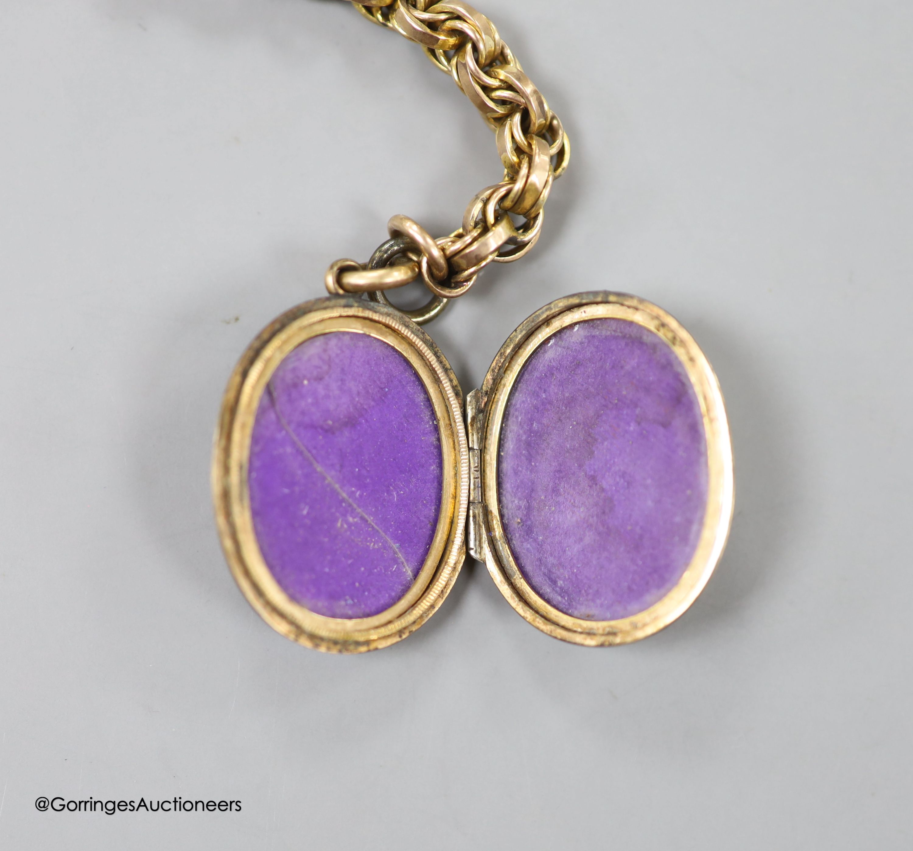 A Victorian gilt metal and enamel oval locket, 29mm, together with a fancy double link albert, stamped 9c, 34.5cm, 25 grams.